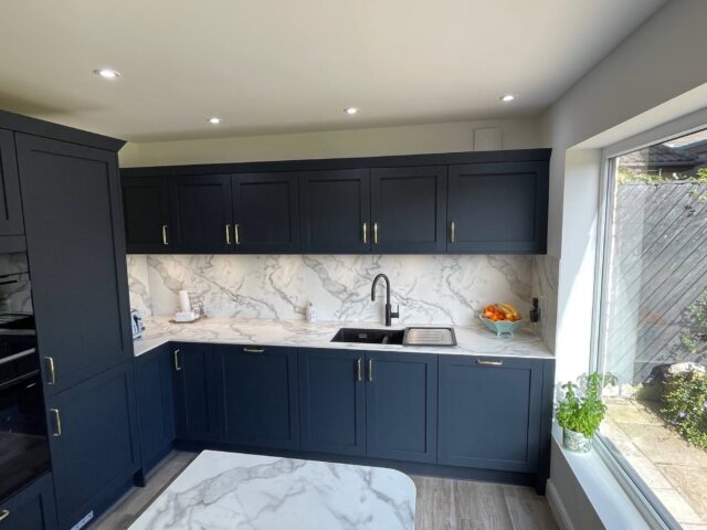Blue handled kitchen with compact laminate worktops